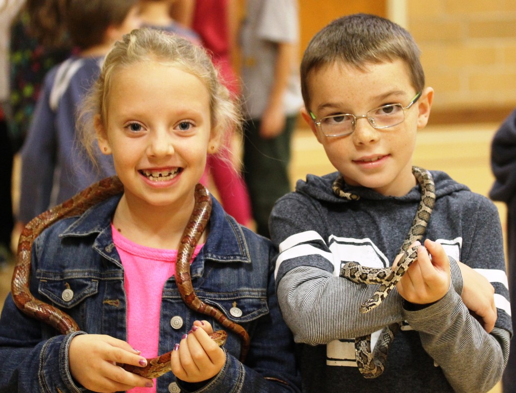 Boy and Girl holding snakes